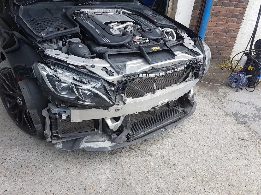 Front-end accident damage on a Mercedes waiting for repair